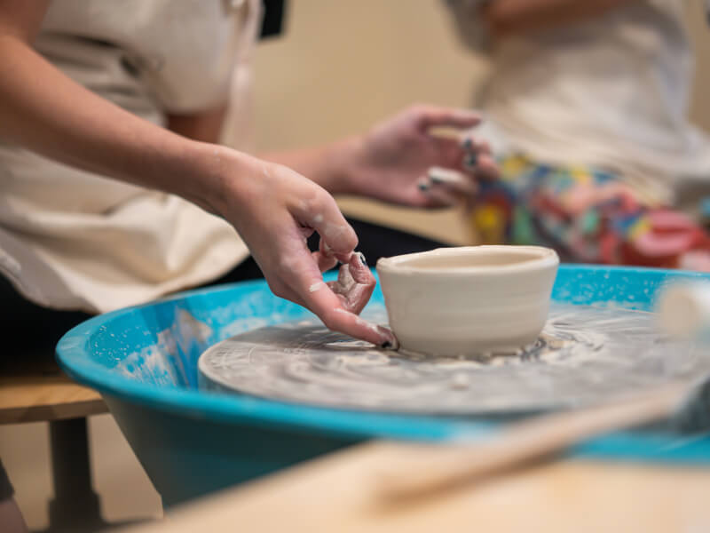Someone makes a pot using wheel throwing